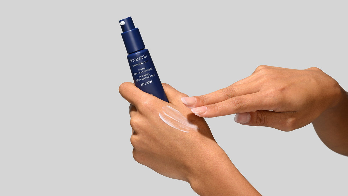Person holding tube of HydroPeptide Eye Authority and applying small amount to hand