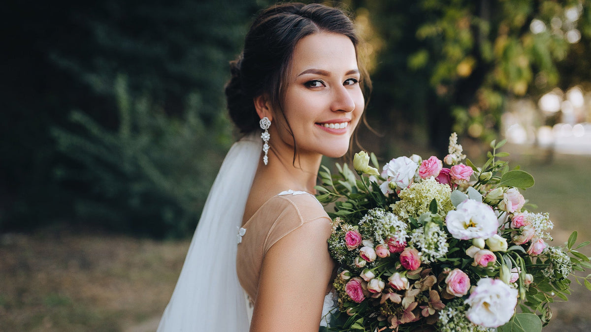 Woman in bridal gown holding bouquet of flowers