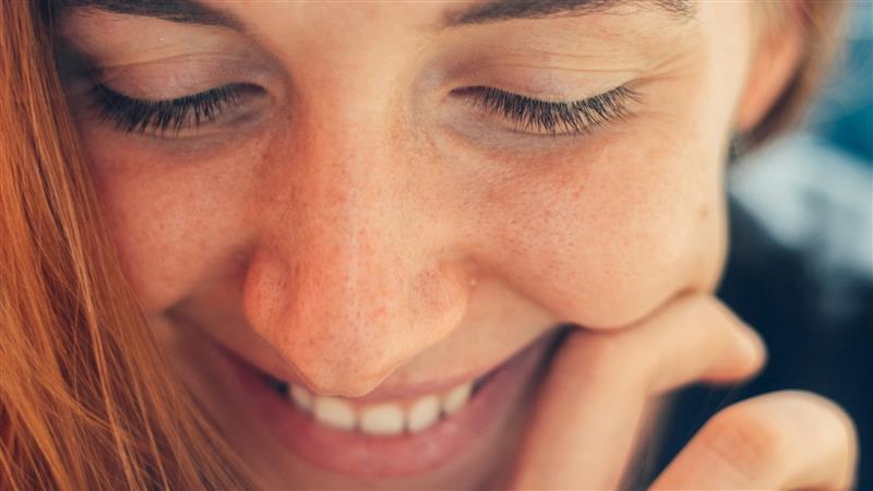 Woman smiling and looking down