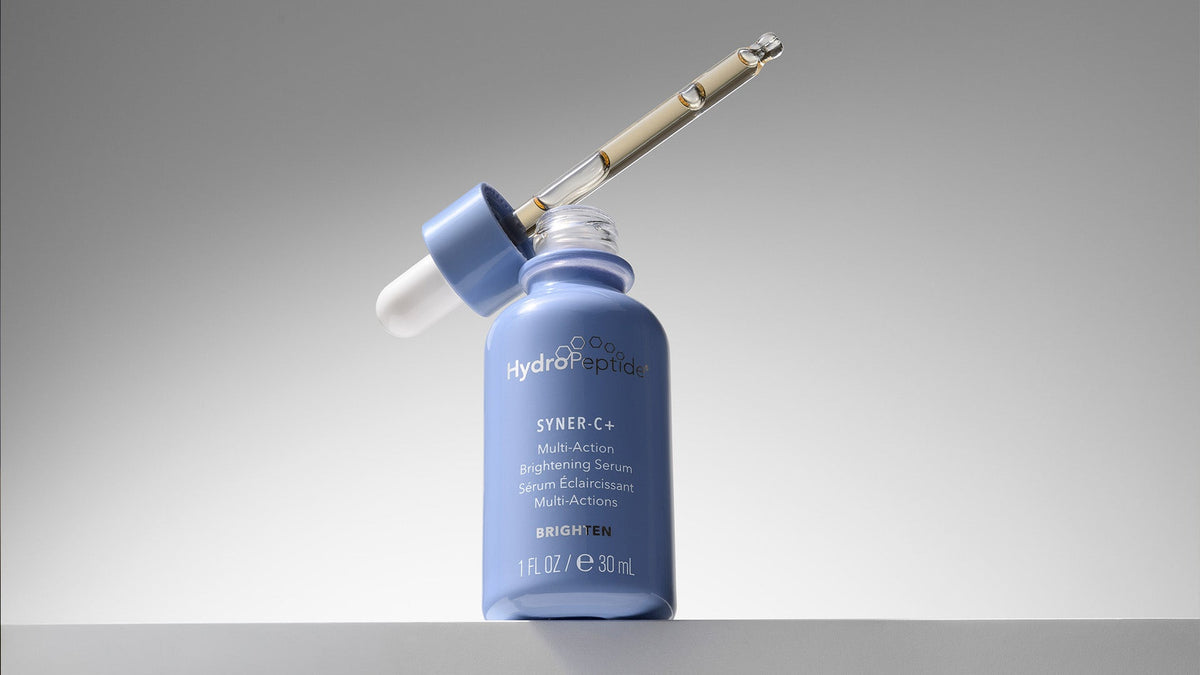 HydroPeptide Syner-C Serum light lavender bottle with dropper filled with light gold liquidr 