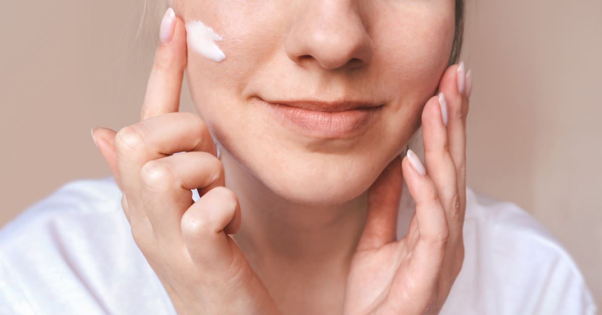 Woman applying gentle moisturizer