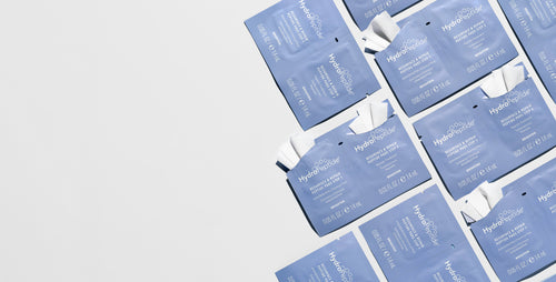 HydroPeptide Resurface and Repair peptide Peel pad sachets on a grey background