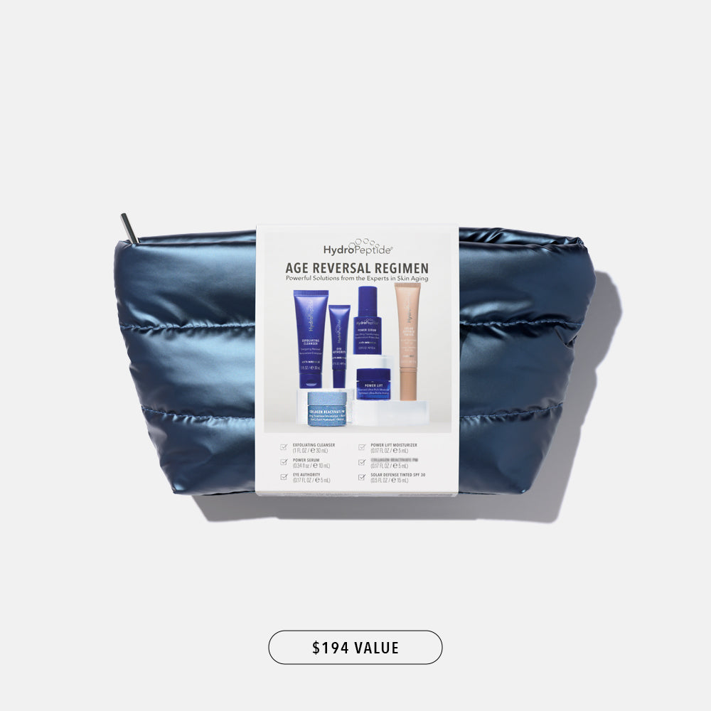 Skincare Set with packaging labeled 'Age Reversal Regimen' on a grey background