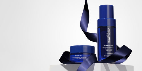 Blue skincare products with a ribbon on a light gray background