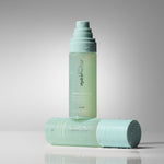 Two pale mint green HydroPeptide HydraFlora Mist bottles, arranged on a neutral gray studio background.