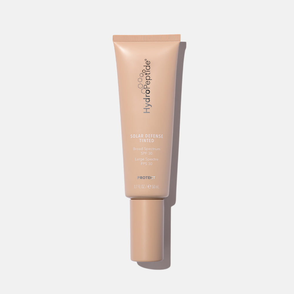 Tube of Hydropeptide Solar Defense Tinted moisturizer on a light gray background